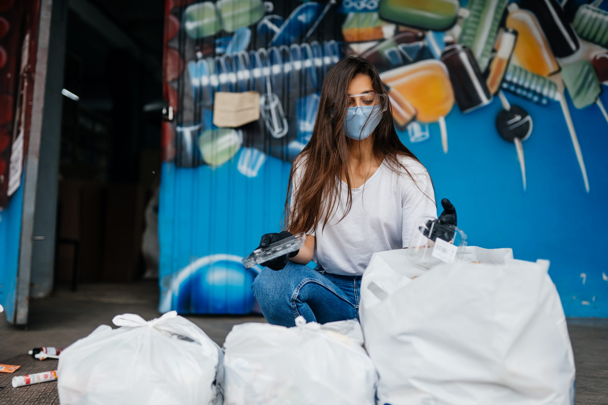 Young woman sorting garbage. Concept of recycling.
