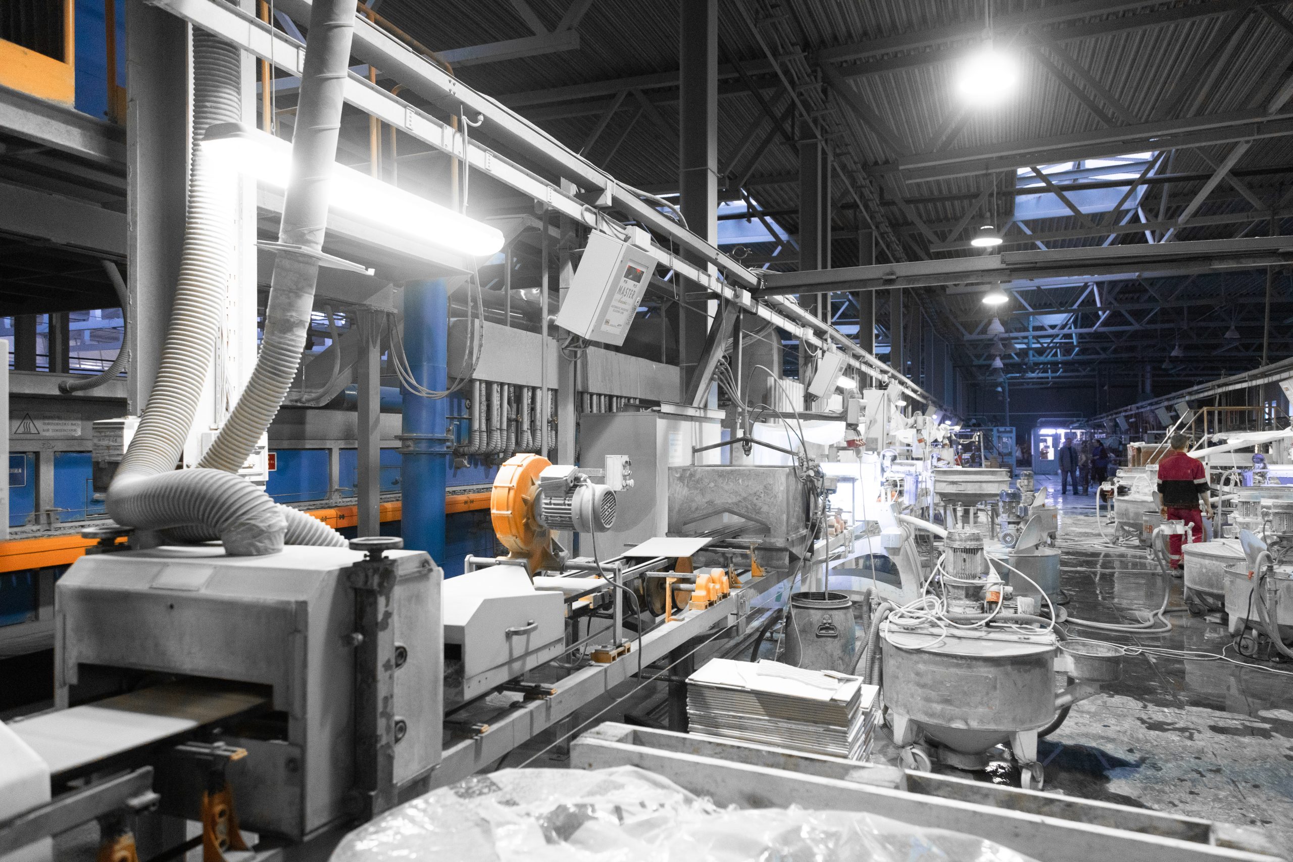 Cement factory interiors. Industrial cement production conveyor. Workers in the shop on the production line