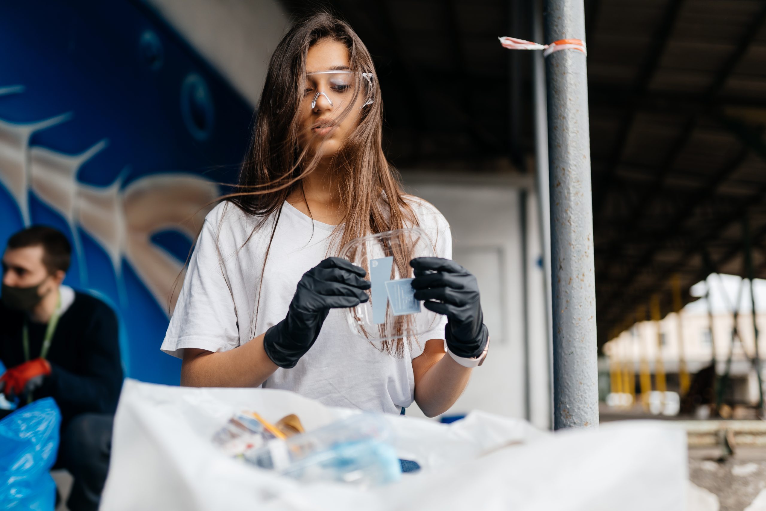 Young woman sorting garbage. Concept of recycling.