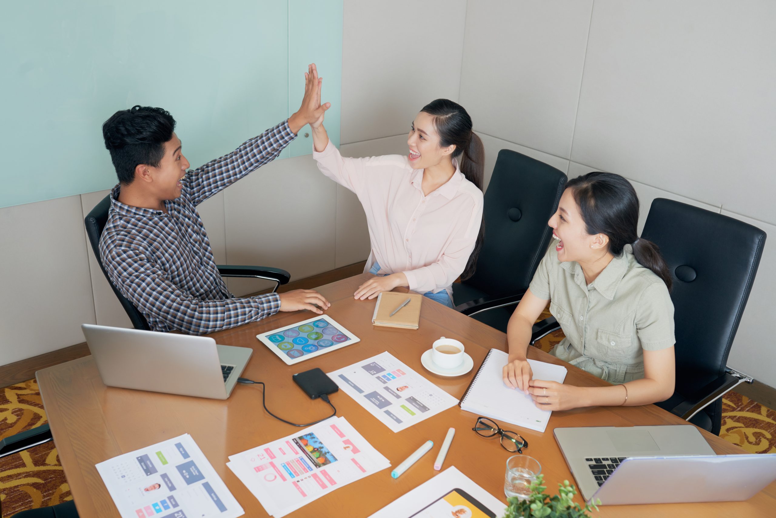 Business people giving high five after first success