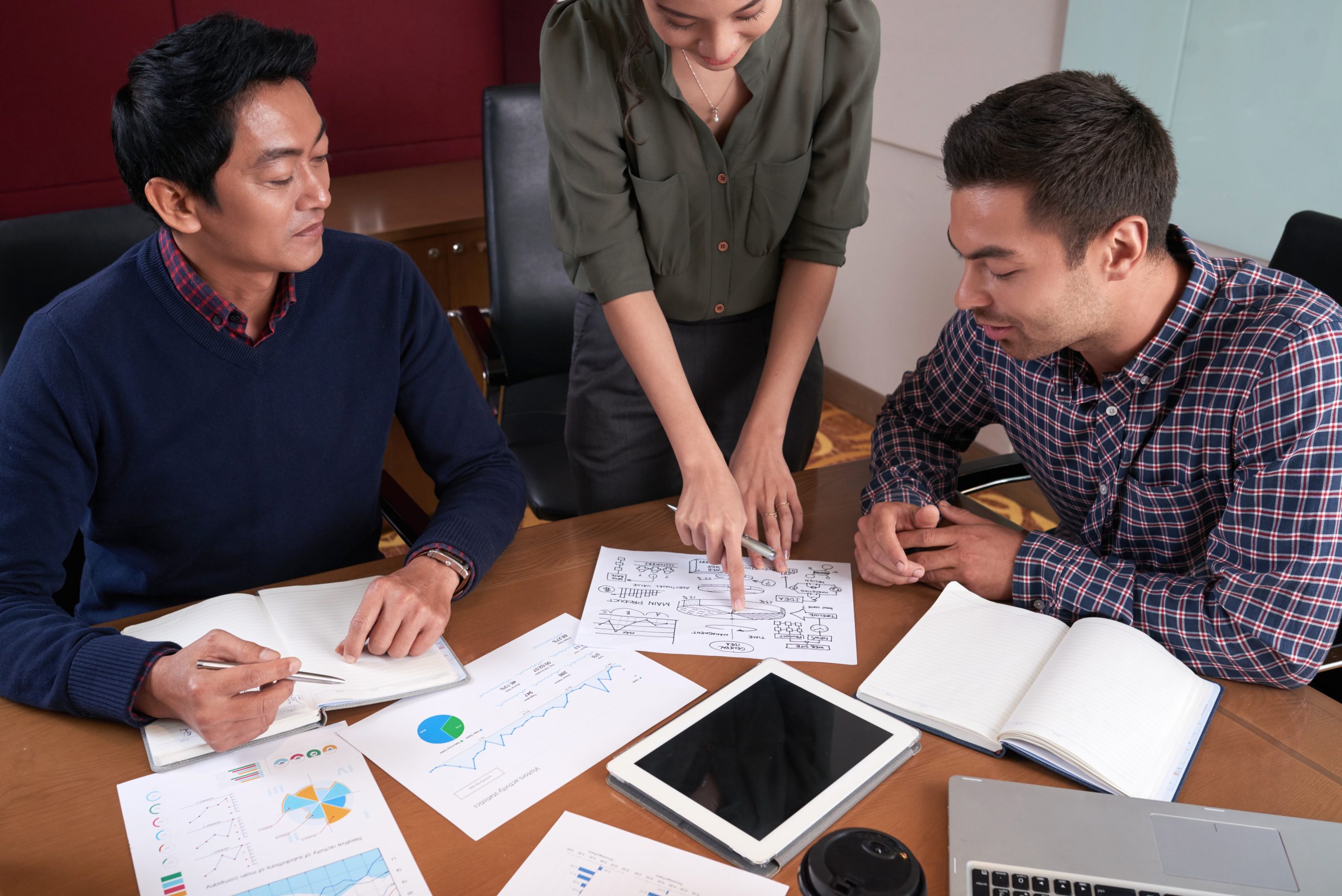 Business lady showing general idea plan to coworkers