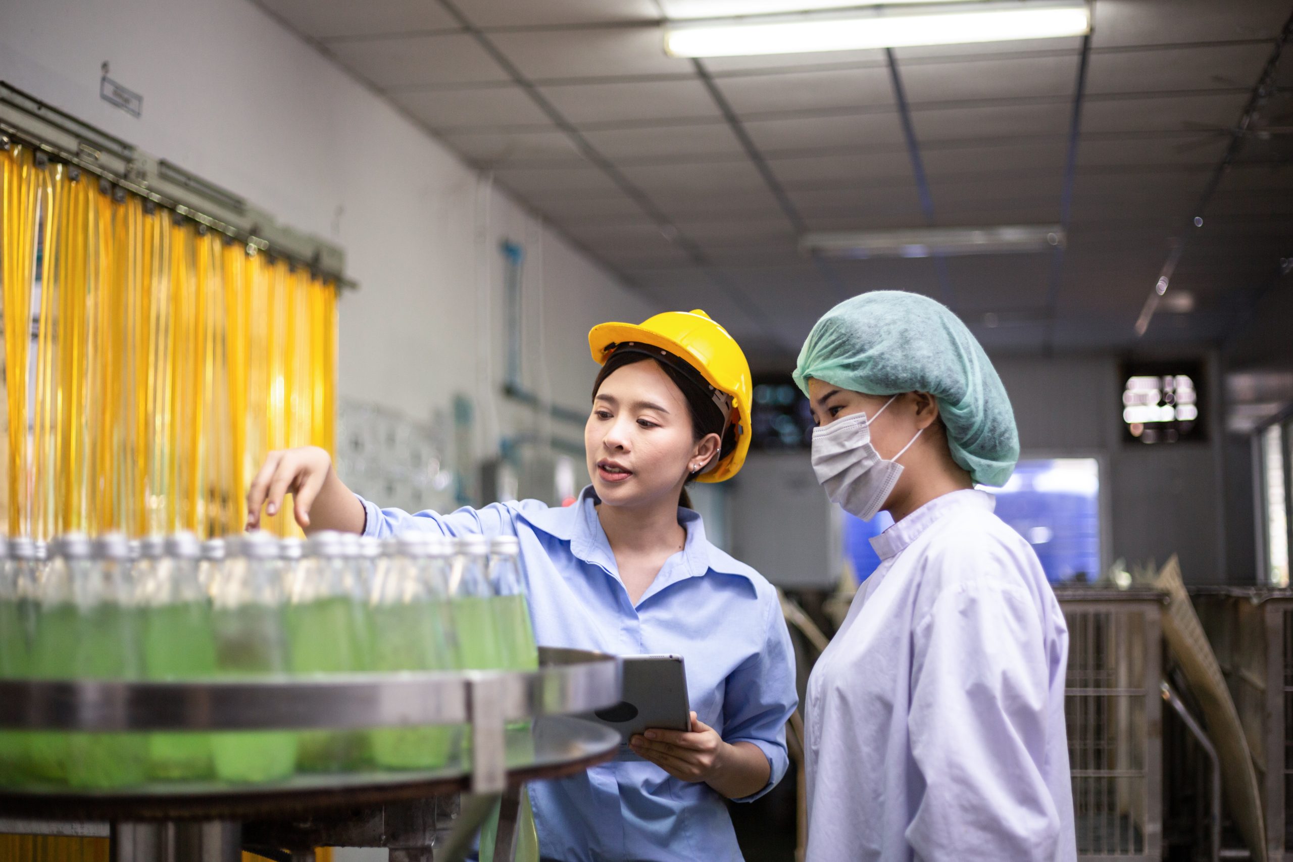 asian-female-workers-checking-quality-control-drink-factory