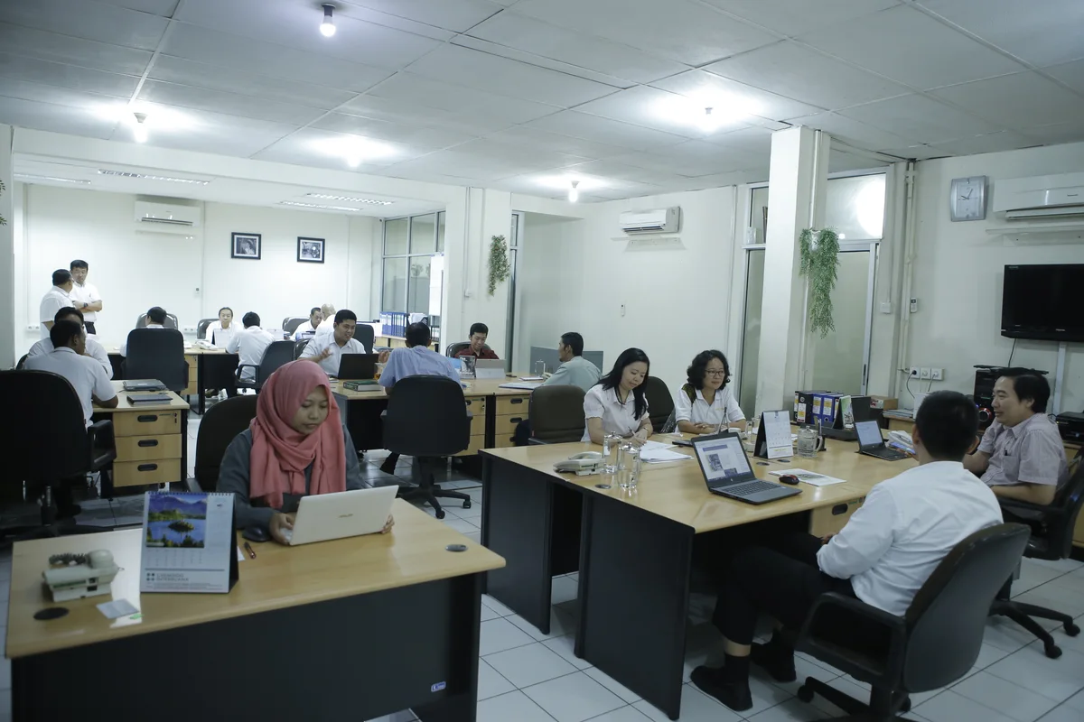 Tim Chemindo bekerja bersama di kantor dengan tata ruang terbuka